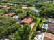 This is an aerial shot of a luxury home with a red tiled roof, pool, and well-manicured lawn at 1813 Glenbay Ct, Windermere, FL 34786