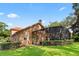 Beautiful backyard featuring a screened lanai, mature trees, and lush landscaping at 1813 Glenbay Ct, Windermere, FL 34786