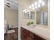 Bathroom vanity with warm lighting, a sink, and a view of a second vanity and the bedroom beyond at 1813 Glenbay Ct, Windermere, FL 34786