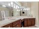 Bathroom featuring double sinks, marble countertops and a large mirror with elegant lighting at 1813 Glenbay Ct, Windermere, FL 34786
