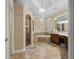 Luxurious bathroom featuring a soaking tub, tiled shower, and dual vanities at 1813 Glenbay Ct, Windermere, FL 34786