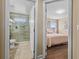 A bathroom with a large glass shower and views through an open doorway to a bedroom at 1813 Glenbay Ct, Windermere, FL 34786