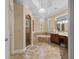 Spacious bathroom with a separate shower, soaking tub, vanity, and neutral tile flooring at 1813 Glenbay Ct, Windermere, FL 34786