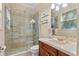 Updated bathroom with tiled shower, glass door, modern vanity, and great lighting at 1813 Glenbay Ct, Windermere, FL 34786