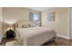 A bright bedroom with hardwood floors, a queen bed, and natural lighting at 1813 Glenbay Ct, Windermere, FL 34786