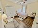 Cozy bedroom featuring a ceiling fan, closet, and desk area with natural lighting at 1813 Glenbay Ct, Windermere, FL 34786