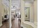Spacious bedroom featuring wood floors, a ceiling fan, access to a patio, and a mirror-lined dressing area at 1813 Glenbay Ct, Windermere, FL 34786