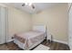 Bedroom featuring wood floors, a bed with white headboard, and a ceiling fan for comfort at 1813 Glenbay Ct, Windermere, FL 34786