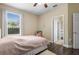 Bright bedroom features a ceiling fan, wood floors, and a large window at 1813 Glenbay Ct, Windermere, FL 34786