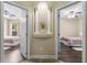 View through the hallway into two bedrooms, each with wood floors and ceiling fans at 1813 Glenbay Ct, Windermere, FL 34786