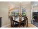 Cozy dining area with a dark wood table, seating for four, and views of the pool at 1813 Glenbay Ct, Windermere, FL 34786