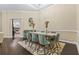 Formal dining room with modern table and chairs under a tray ceiling and chandelier at 1813 Glenbay Ct, Windermere, FL 34786