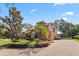 Charming exterior view of a stucco home with a terra cotta roof, lush landscaping, and a brick driveway in a sunny setting at 1813 Glenbay Ct, Windermere, FL 34786