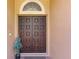 Elegant double front door with dark wood finish and sidelight window at 1813 Glenbay Ct, Windermere, FL 34786