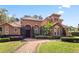 Beautiful Mediterranean-style home with well-manicured landscaping and a red tile roof at 1813 Glenbay Ct, Windermere, FL 34786