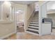 Hallway with stairs, doorway views to bedrooms, and laundry appliances visible at 1813 Glenbay Ct, Windermere, FL 34786