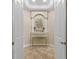 Beautiful hallway with architectural niche, white columns, decor, and tile flooring at 1813 Glenbay Ct, Windermere, FL 34786