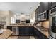 Stylish kitchen boasts dark cabinetry, stainless steel appliances, granite countertops, and a breakfast bar at 1813 Glenbay Ct, Windermere, FL 34786