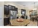 Open kitchen boasts a granite island, stainless appliances, and opens to breakfast nook at 1813 Glenbay Ct, Windermere, FL 34786