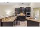 Open kitchen features dark wood cabinets, granite countertops, stainless appliances, and a breakfast bar at 1813 Glenbay Ct, Windermere, FL 34786