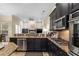 Open kitchen features granite countertops, stainless steel appliances, and view of the fireplace at 1813 Glenbay Ct, Windermere, FL 34786