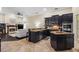 Open-concept kitchen with black cabinetry, granite countertops, stainless steel appliances and tile floors at 1813 Glenbay Ct, Windermere, FL 34786