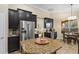 Charming kitchen with dark wood cabinets, stainless steel appliances, and a center island with granite countertop at 1813 Glenbay Ct, Windermere, FL 34786