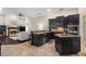 Open-concept kitchen with island, granite countertops, stainless appliances, and dark wood cabinetry at 1813 Glenbay Ct, Windermere, FL 34786