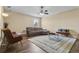 Living room offering hardwood floors, ceiling fan, and multiple seating options at 1813 Glenbay Ct, Windermere, FL 34786
