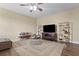 Living room featuring wood floors, a large rug, and a large screen television at 1813 Glenbay Ct, Windermere, FL 34786