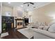 Comfortable living room featuring a fireplace, built-in cabinets, hardwood floors, and neutral-toned furniture at 1813 Glenbay Ct, Windermere, FL 34786