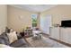 This playroom has neutral walls, a large window, and includes a gray sofa and a small table set at 1813 Glenbay Ct, Windermere, FL 34786