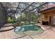The screened-in pool features a stone waterfall and a surrounding brick patio, offering a serene outdoor oasis at 1813 Glenbay Ct, Windermere, FL 34786