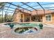 Inviting pool area with a hot tub, brick pavers, a screened enclosure, and a covered outdoor kitchen at 1813 Glenbay Ct, Windermere, FL 34786