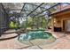 Backyard oasis with pool, spa, lush landscaping, and screened-in patio at 1813 Glenbay Ct, Windermere, FL 34786