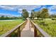 View of community tennis court accessible via walking bridge at 1813 Glenbay Ct, Windermere, FL 34786