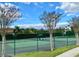 Community tennis court surrounded by lush greenery and trees at 1813 Glenbay Ct, Windermere, FL 34786