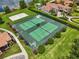 Aerial view of tennis courts showing well maintained grounds surrounded by manicured landscaping at 1813 Glenbay Ct, Windermere, FL 34786