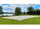 Outdoor sand volleyball court for community fun with a water view in a residential community at 1813 Glenbay Ct, Windermere, FL 34786