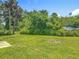Lush backyard with green grass and mature trees, perfect for outdoor enjoyment at 1816 Alexander Ave, Sanford, FL 32771