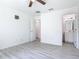Open bedroom featuring wood-look floors and a glimpse into an ensuite bath at 1816 Alexander Ave, Sanford, FL 32771