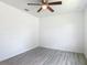 Bright bedroom featuring wood-look flooring and a ceiling fan for added comfort at 1816 Alexander Ave, Sanford, FL 32771