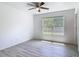 Bright bedroom with wood-look floors and a view from a large window at 1816 Alexander Ave, Sanford, FL 32771