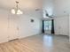 Spacious living room with wood look flooring, white walls, a ceiling fan, and multiple doors at 1816 Alexander Ave, Sanford, FL 32771