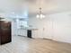 Open-concept living space featuring wood look flooring and white walls, seamlessly connecting to the kitchen at 1816 Alexander Ave, Sanford, FL 32771