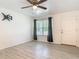 Bright living room showcasing gray wood look flooring, white walls, a ceiling fan, and a window at 1816 Alexander Ave, Sanford, FL 32771