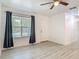 Bright living room with wood look flooring, a ceiling fan, and dark colored curtains at 1816 Alexander Ave, Sanford, FL 32771