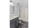 Clean bathroom features a shower/tub combo, white tiled walls, and a gray vanity at 1905 Emily Blvd, Winter Haven, FL 33884