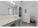 Bathroom features a large mirror, gray vanity, and bright lighting at 1905 Emily Blvd, Winter Haven, FL 33884