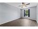 Bright bedroom featuring wood-look flooring, a ceiling fan, and a window with curtains at 1905 Emily Blvd, Winter Haven, FL 33884